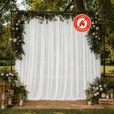 Outdoor floral wedding backdrop with white drapes and flame-retardant sign