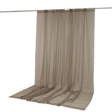 Beige sheer curtain panel hanging on a rod against a white background