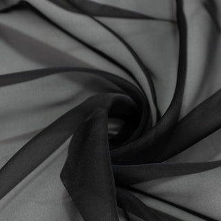 Black sheer fabric close-up with elegant layered folds and texture#whtbkgd