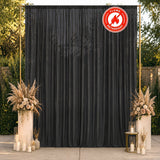 Black flame-retardant curtain backdrop with elegant floral wedding decor outdoors