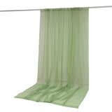 Light green sheer curtain panel hanging on a rod