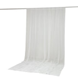 White sheer curtain panel hanging from a rod, floor-length drapery
