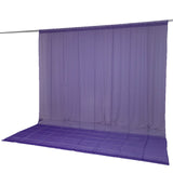 Purple translucent curtain backdrop with matching floor mat on a rod