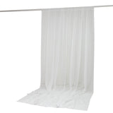 White sheer curtain panel hanging on a rod with soft draped fabric
