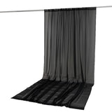 Black sheer curtain panel hanging on rod with floor-length drape#whtbkgd