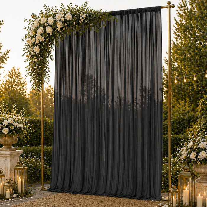 Elegant outdoor wedding backdrop with black drape, roses, lanterns, and gold frame