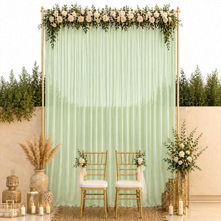 Elegant wedding backdrop with mint drapes, white roses, gold chairs and lanterns
