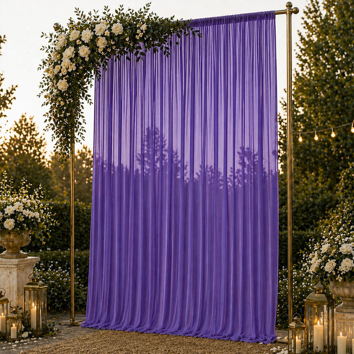 Purple wedding backdrop with floral arch, lanterns, and romantic outdoor decor
