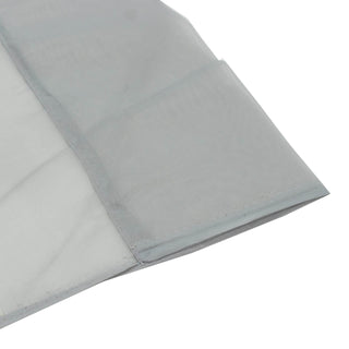 Light gray sheer curtain fabric close-up with hem stitching