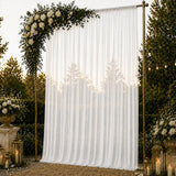 Elegant wedding backdrop with white drapes, roses, and gold lanterns