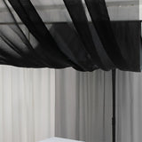 Black sheer canopy draped over a minimalist setup.