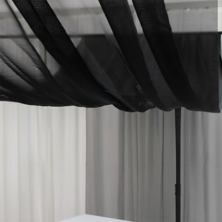 Black sheer canopy draped over a minimalist setup.