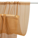 Sheer caramel curtain draped on a rod for elegant window treatment #whtbkgd