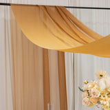 Sheer amber fabric draped elegantly above a floral arrangement.