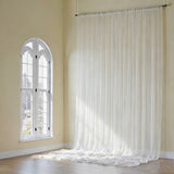 Sheer white curtains draped elegantly in a bright room.