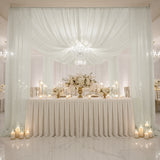 Elegant wedding reception setup with floral arrangements and soft lighting.
