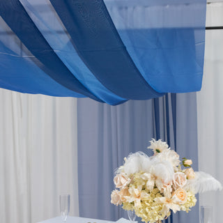 Elegant floral arrangement with blue drapery backdrop.