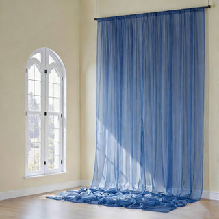 Sheer blue curtains draping elegantly in a sunlit room.