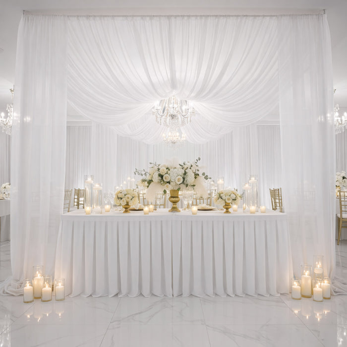 Elegant wedding reception decor with white flowers and candles.