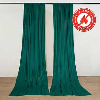 Flame-retardant green curtains hanging on a wall with certification seal
