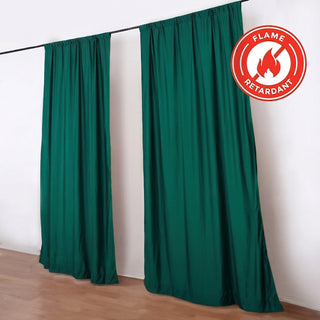 Green flame retardant curtains hanging on a black rod indoors