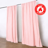 Pink flame retardant curtains on rod with fire safety badge
