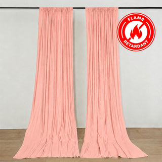 Pink flame retardant curtains hanging on a wall, labeled fire resistant.