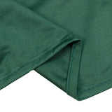 Green ribbed knit fabric close-up with folded hem detail
