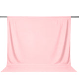 Light pink curtain draped on a metal rod, studio product image