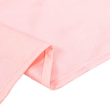 Close-up of a light pink ribbed knit fabric with folded hem details