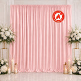 Pink flame retardant curtain backdrop with floral arrangements and candles