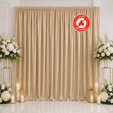 Elegant beige wedding backdrop with white floral arrangements and candles