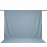 Light blue seamless photography backdrop on a support bar