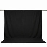 Black photography backdrop cloth on support rod, studio background setup