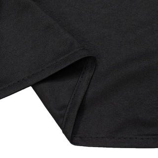 Black ribbed knit fabric close-up with folded seam detail