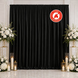 Black flame retardant curtain backdrop with white floral decor and candles