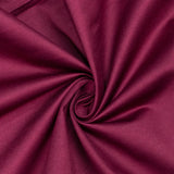 Close-up of magenta fabric swirl texture with soft folds#whtbkgd
