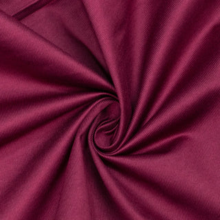 Close-up of magenta fabric swirl texture with soft folds#whtbkgd
