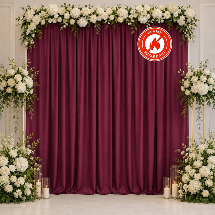 Elegant floral wedding backdrop with burgundy curtains and flame retardant logo