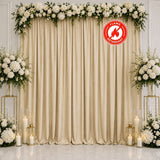Elegant white floral wedding backdrop with gold curtains and candles