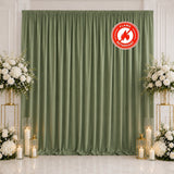 Sage green flame-retardant backdrop with floral wedding decor and candles