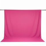 Pink sheer backdrop fabric hanging on a rod, studio product display