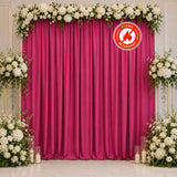 Floral magenta wedding backdrop with white roses and fire-retardant curtain