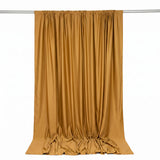 Golden satin curtain draped on a rod against a white background