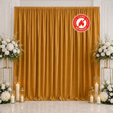 Gold wedding backdrop with white floral arrangements and candles, flame retardant style
