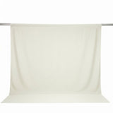 Cream seamless backdrop curtain on a hanging studio support rod