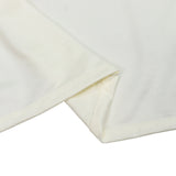Folded ivory ribbed fabric texture close-up on white background