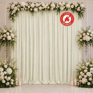 Elegant white floral wedding backdrop with cream drapes and candles, flame retardant