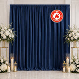 Navy blue wedding backdrop with white floral arrangements and candles
