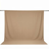 Beige seamless backdrop curtain on support stand